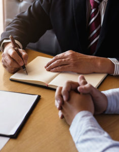 lawyer and client working on documents in office