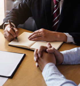 lawyer and client signing papers